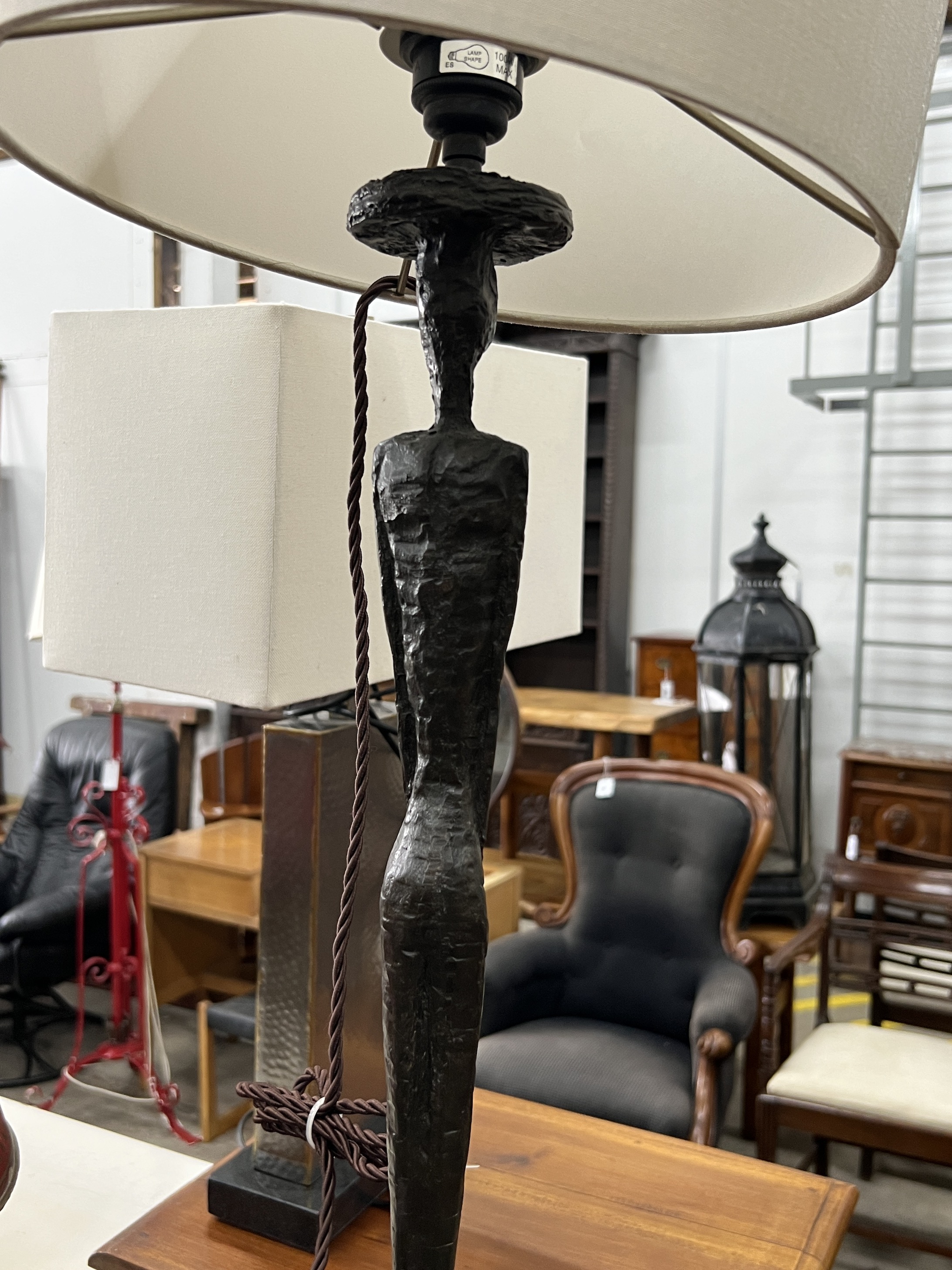 A pair of contemporary bronzed resin figural table lamps and shades, height including shades 97cm